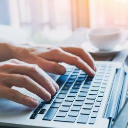 close up of hands of business person working on computer, man using internet and social media